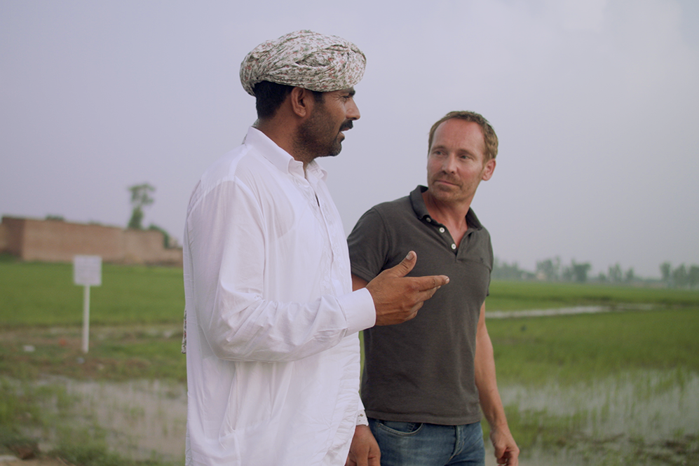 Two men walking and having a conversation.
